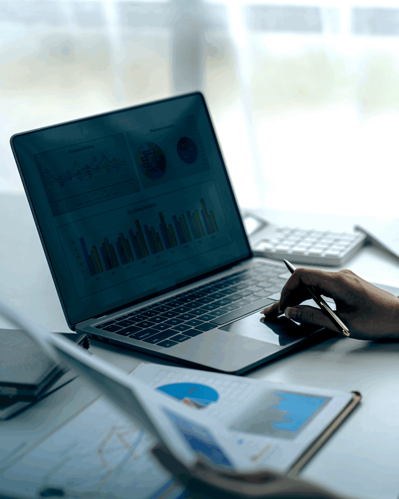 Projectmanager bekijkt grafieken op laptop tijdens planning.